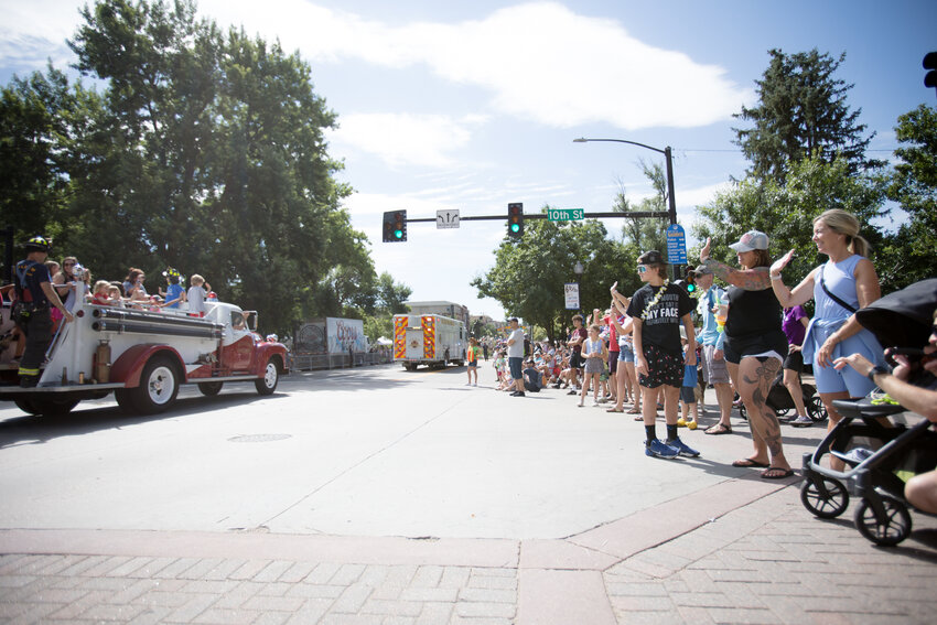People wave to the fire department during the Buffalo Bill Days parade Saturday morning.